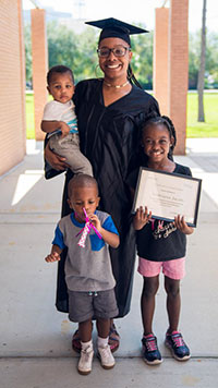 Generation IT student poses with her family at a graduation ceremony in Jacksonville, FL